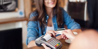 Women paying the bill using credit card