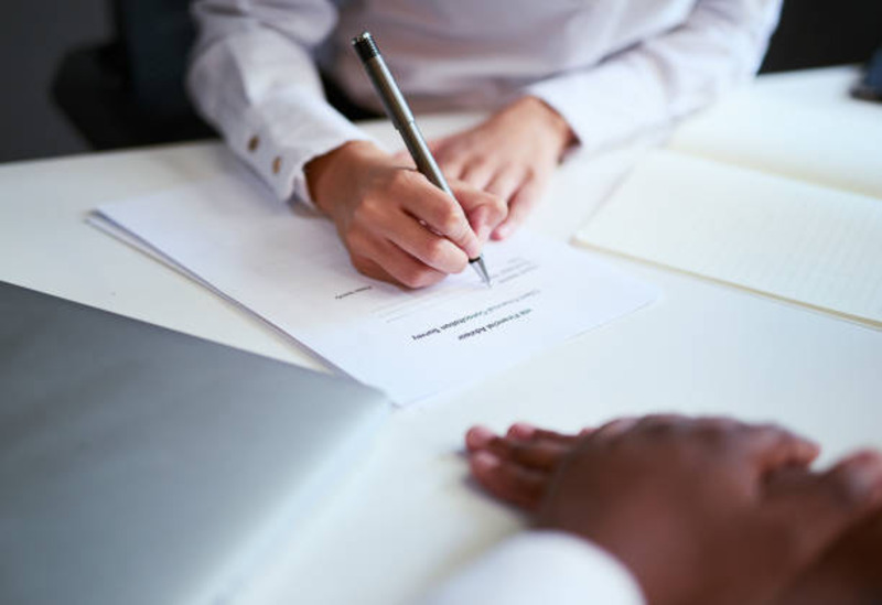 Man writing on paper about legal action