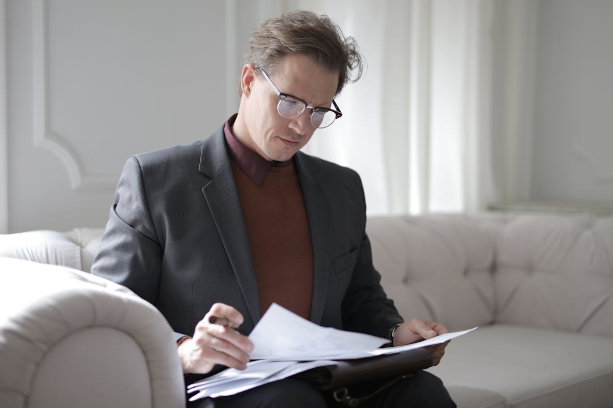 a person reading documents delivered by a process server