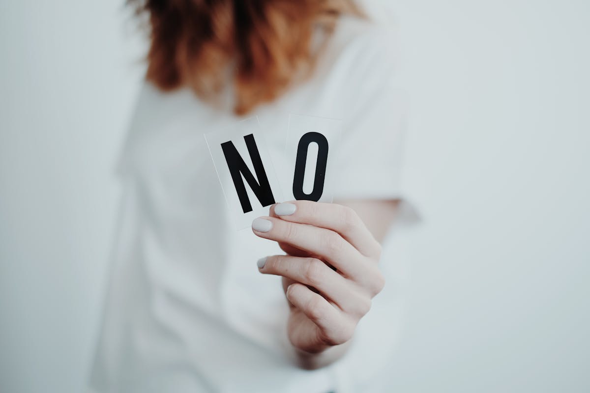 a person holding the letters “N” and “O”, indicating mistakes to avoid when filing proof of service forms