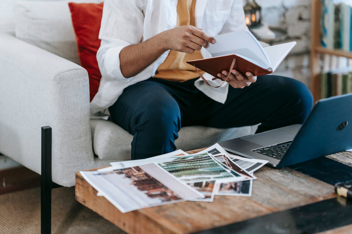 Designer working with photos and laptop