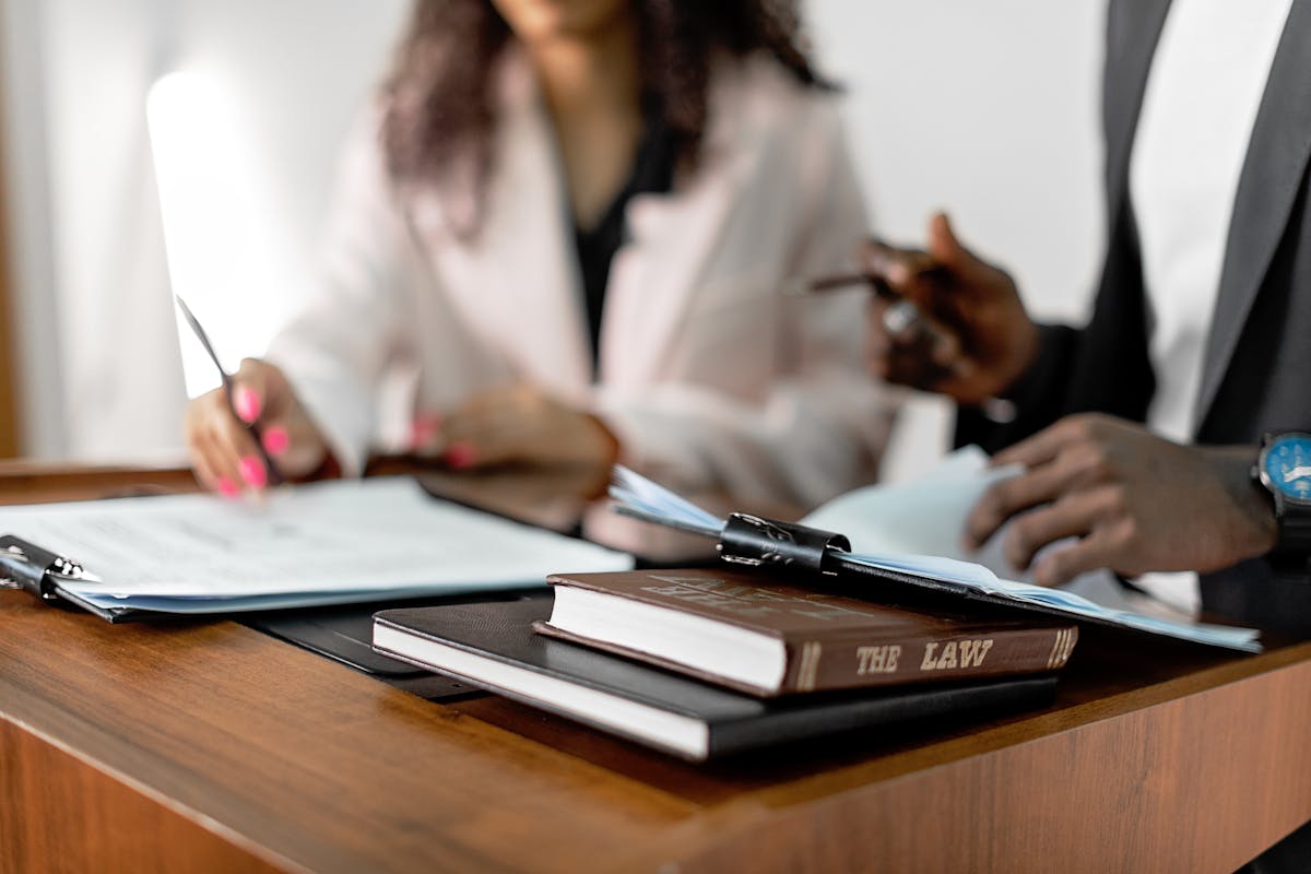 Process server delivering legal documents with law books on a desk