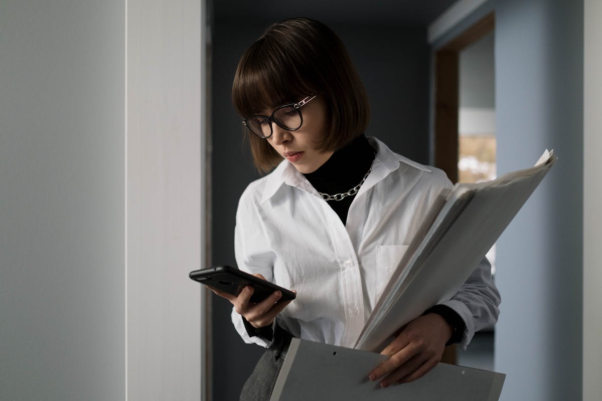 Process server organizing and reviewing legal documents in an office