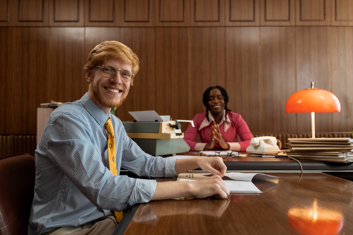 Professional setting where a man gets papers served to him with a smile