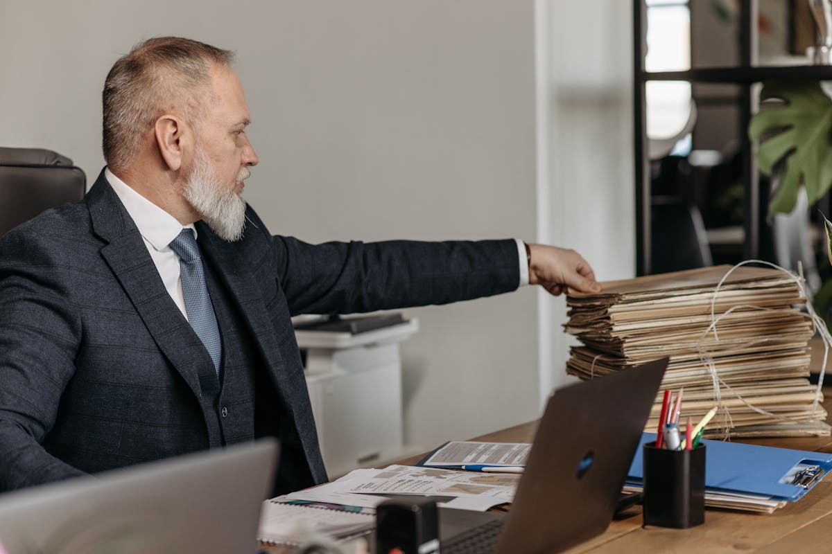 Two business professionals reviewing legal documents after getting papers served to them